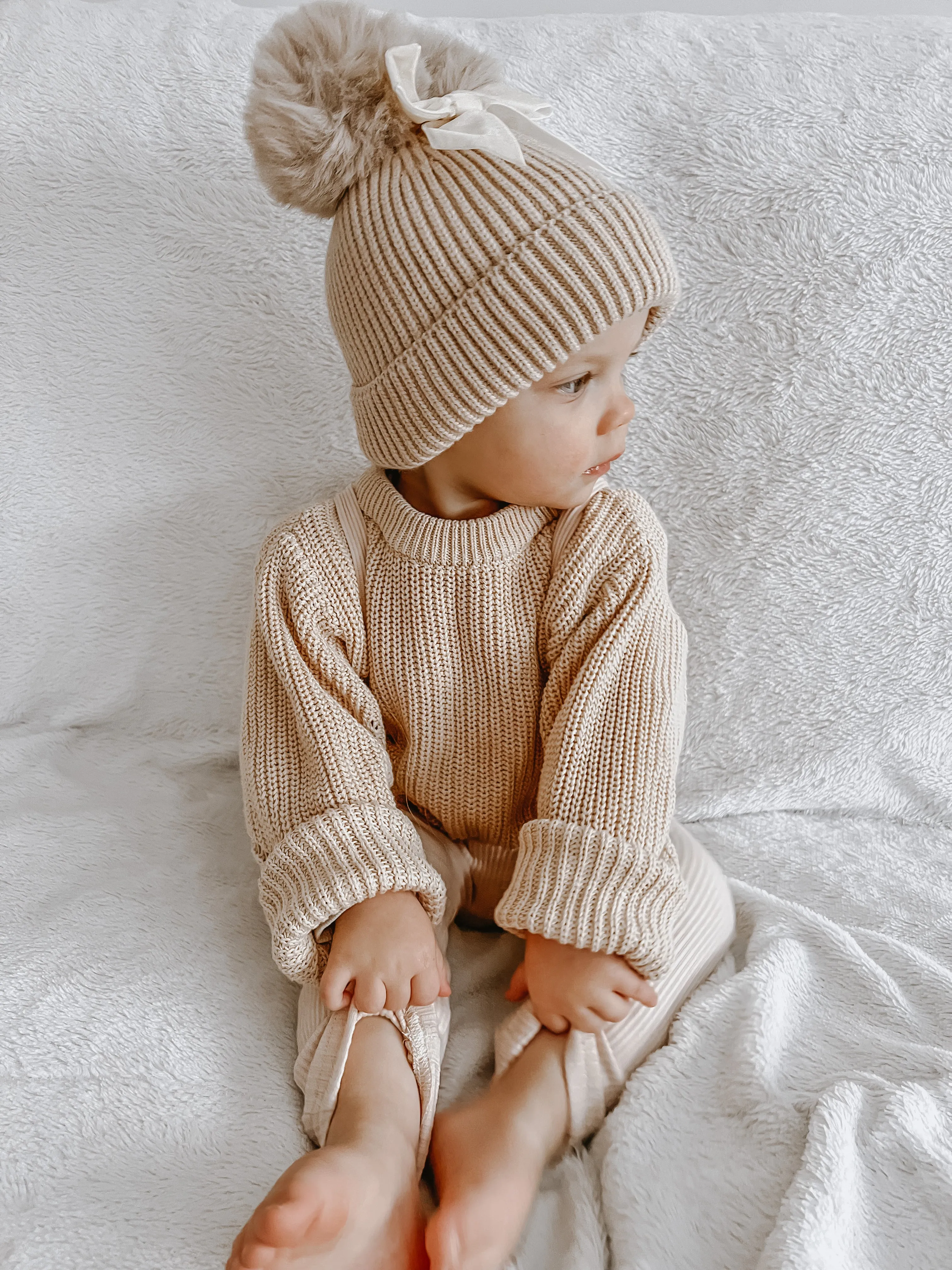 Knitted pompom hat with velvet bow